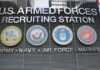Sign for U.S. Armed Forces Recruiting Station with military branch emblems