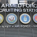 Sign for U.S. Armed Forces Recruiting Station with military branch emblems