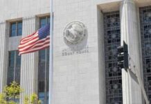 Antifa Stalking Alleged: Officers Hunted Homeward United States courthouse facade with American flag at half-mast