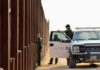 U.S. Customs and Border Protection officers near a border fence