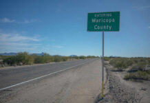 Road sign indicating entry into Maricopa County with a clear blue sky