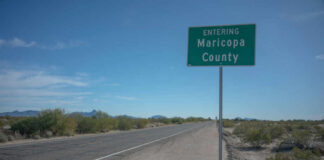 Road sign indicating entry into Maricopa County with a clear blue sky