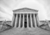 Front view of the Supreme Court building with columns and statues