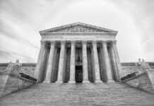 Parking Lot Meltdown: Federal Judge Charged Front view of the Supreme Court building with columns and statues