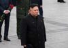 North Korea Locks In Nuclear Escalation A political figure in formal attire participating in a solemn ceremony