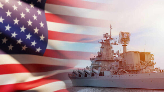 A naval ship with the American flag in the foreground