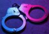 Vetting Collapse? Belfast Horror Ignites Fury Close-up of metallic handcuffs illuminated with neon lights