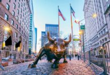 Bronze charging bull sculpture in a city street