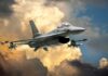 A fighter jet flying through a dramatic cloudy sky
