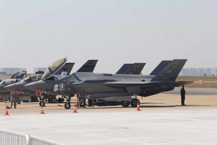On,14th,February,2023,,The,Lockheed,Martin,F-35,Fighter,Jet F-35 military jets parked on an airfield with crew members nearby