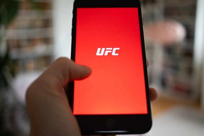 Hand holding smartphone with red app screen