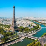 Heatwave Deaths Spike — Paris On Edge Aerial view of the Eiffel Tower in Paris with the Seine River and cityscape