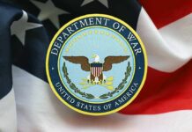 Emblem of the Department of War on a background of the American flag