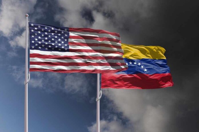 Us,And,Venezuela,Flags,Above,Dark,Sky.,Usa,And,Venezuela Flags of the United States and Venezuela waving against a cloudy sky