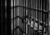 Army Execution Playbook Quietly Activated Close-up of prison bars casting shadows on a wall