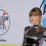 A celebrity posing on the red carpet at the American Music Awards