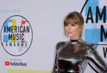 A celebrity posing on the red carpet at the American Music Awards
