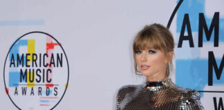 A celebrity posing on the red carpet at the American Music Awards