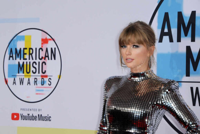 A celebrity posing on the red carpet at the American Music Awards