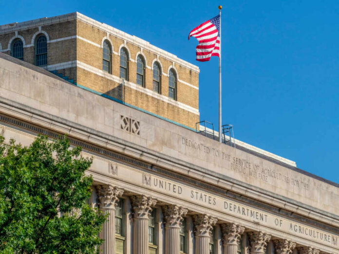 Facade of the United States Department of Agriculture building with an American flag