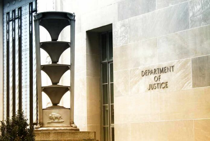 shutterstock_1275008338 Department of Justice building exterior with sign and metal sculpture