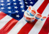 Senator Sparks Domestic Vote Uproar Voting stickers on an American flag background