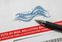 Official election mail envelope with a pen resting on it