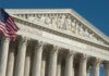 United States Supreme Court facade with flag and Corinthian columns