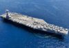 Navy Scraps Space-Skimming Fighter—Why? An aircraft carrier with numerous fighter jets on its deck in the ocean