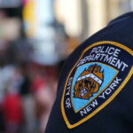 Wild MSG Wedding Sparks NYPD Cash Mystery Close-up of a New York City police badge on a uniform