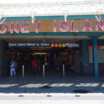 Entrance to Coney Island subway station with people walking