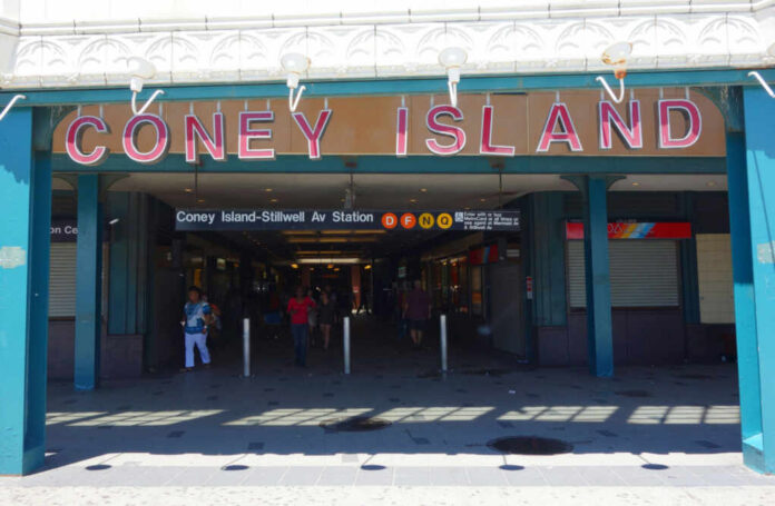 Entrance to Coney Island subway station with people walking
