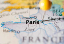 Heatwave Carnage, Elites Debate Comfort Close-up of a map highlighting Paris with a location pin