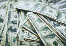 Budget Bombshell Triggers Towson Shake-Up Stacks of U.S. hundred-dollar bills