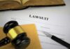 Lawsuit documents with gavel, pen, and legal book