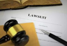 Lawsuit documents with gavel, pen, and legal book