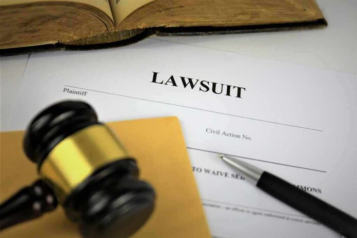 Lawsuit documents with gavel, pen, and legal book