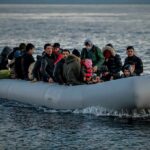Group of people in an inflatable boat on open water