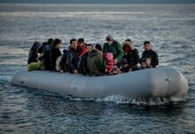 Group of people in an inflatable boat on open water