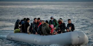 Group of people in an inflatable boat on open water