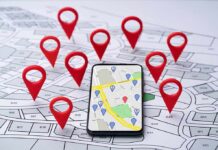 Smartphone with map app surrounded by red location pins