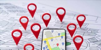 Smartphone with map app surrounded by red location pins
