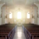 Empty church interior with sunlight at the altar