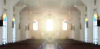 Empty church interior with sunlight at the altar
