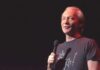 Maher Sparks Gen Z Money Brawl comedian holding a microphone on stage