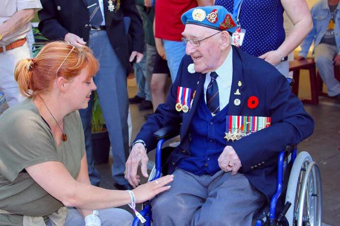 shutterstock_1092689312 Elderly veteran in wheelchair greeted by woman