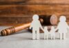 Paper cutout family with gavel in background