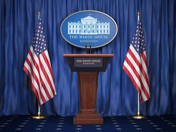 White House press podium with microphones and two American flags