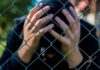Hollywood Stunned: Star Heir Dies In Rehab Person behind chain-link fence holding head in hands