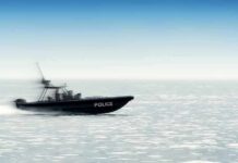 Police patrol boat speeding across open water